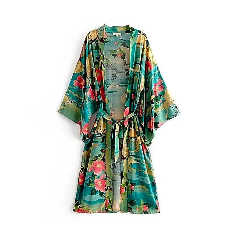 Turkusowa długa sukienka kimono z bawełny organicznej w japoński wzór z żurawiami, widok z przodu, ułożona na płasko.